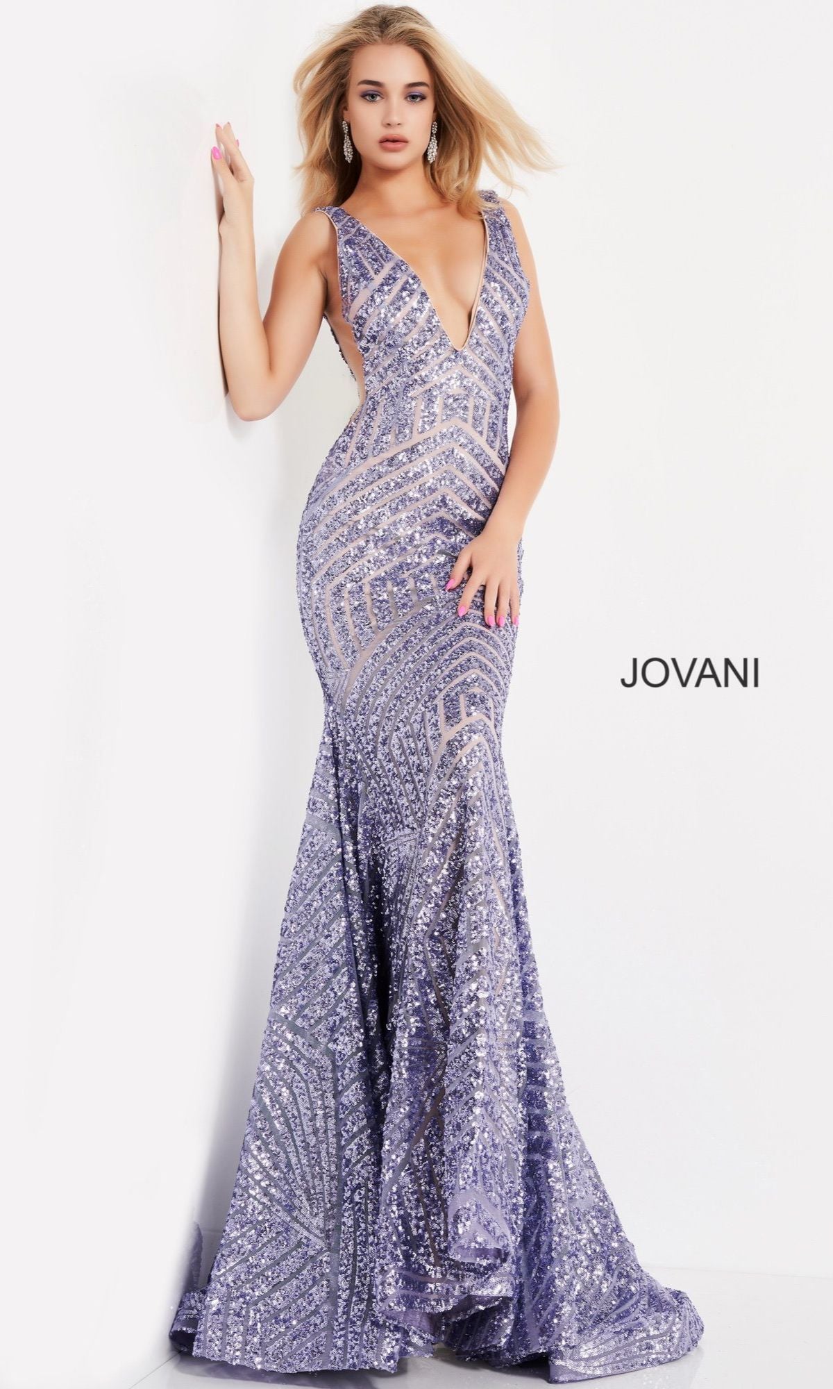 A woman poses in a floor-length sleeveless Jovani Prom Dress with a striped sequin pattern and deep V-neckline against a plain white background.